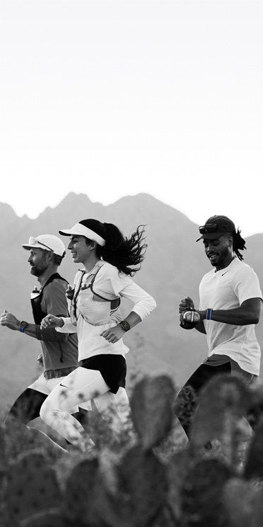 Three people running on a desert trail track their workout on Apple Watch Ultra 3