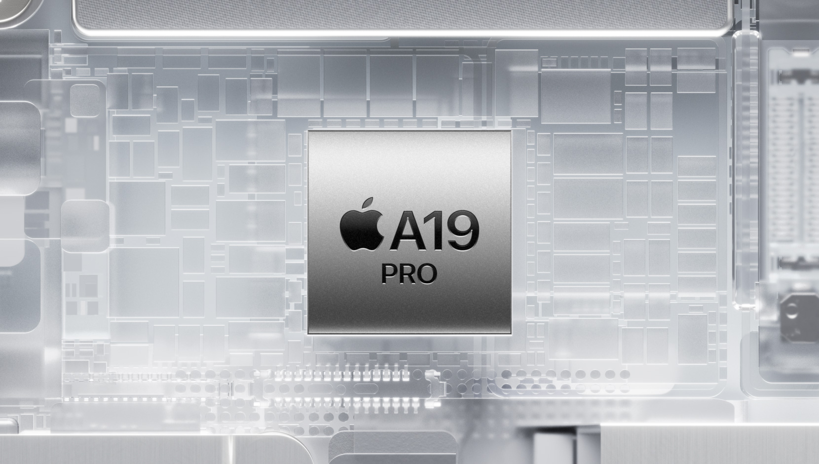 Chip A19 Pro rodeado de los brillantes componentes internos de un iPhone