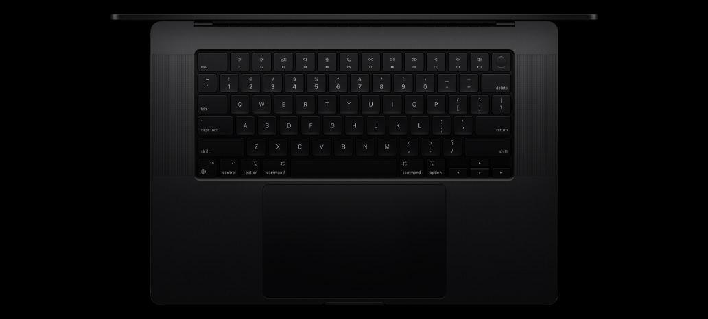 Top-down view of MacBook Pro shows built-in Magic Keyboard with Touch ID and trackpad
